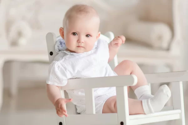 charming newborn boy sits on the chair in the studio 8353 7345 (1)