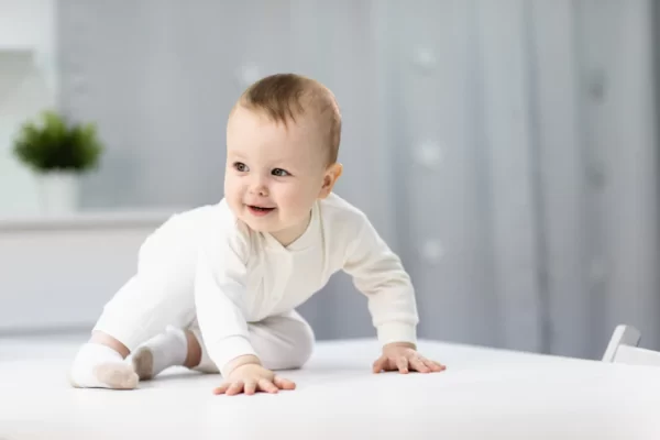 naked baby in a white suit sitting in a bright room 213607 1126