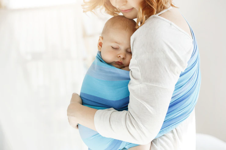 tiny newborn child close eyes and having good sleep in baby sling feeling protection from his beautiful young mother family lifestyle concept 176420 12238
