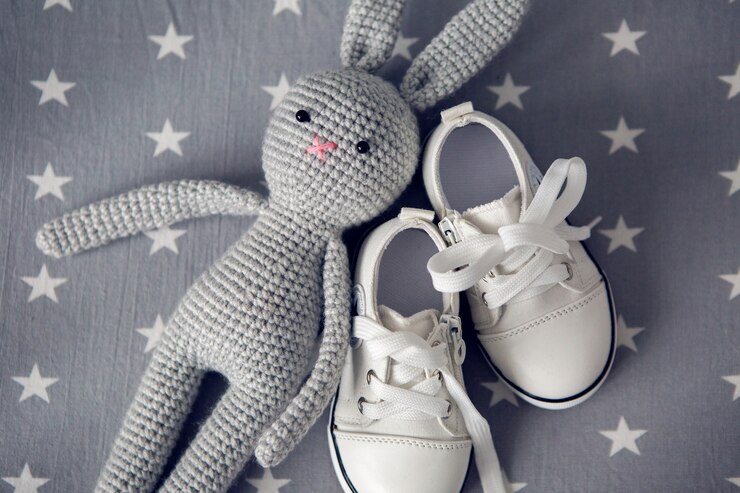 grey knitted toy rabbit and children s white shoes 328654 119